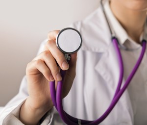 Close-up of female doctor using stethoscope